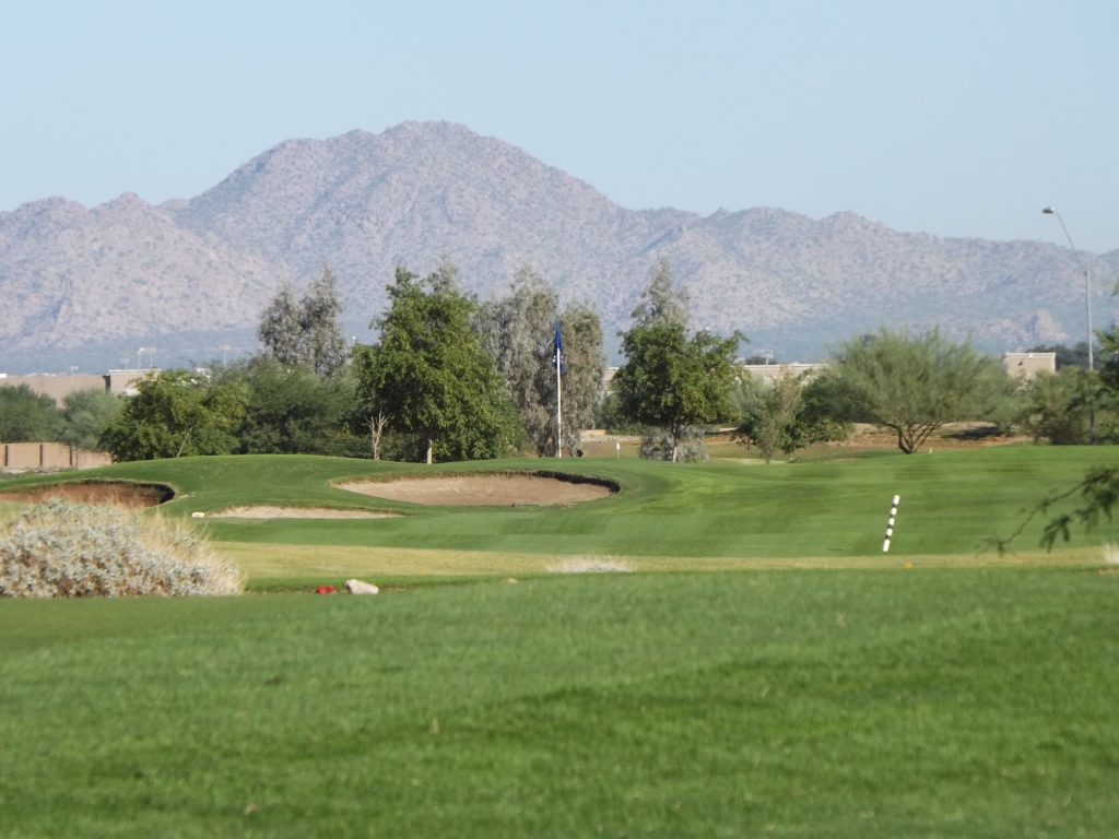 view of the green with scenic mountains in the background